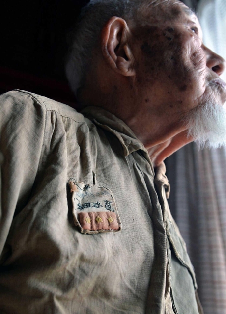 ビルマで着ていた軍服に袖を通し、当時を回想する細谷寛さん＝神戸市垂水区本多聞４（撮影・風斗雅博）