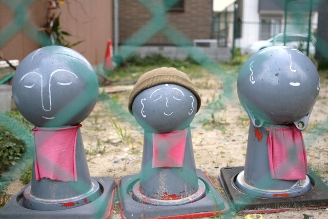 空き地にたたずむお地蔵さま。震災前は、この場所にくしカツ屋があった＝神戸市長田区川西通４