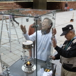 東遊園地のガス灯「１・１７希望の灯り」を清掃するＨＡＮＤＳのメンバー＝１６日、神戸市中央区加納町６