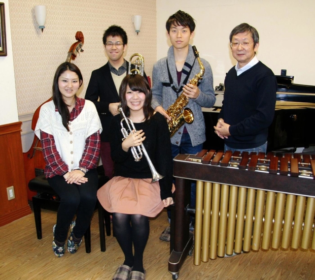 ４月にプロの吹奏楽団「ＩＭＭＣウィンドオーケストラ」を立ち上げる石野靖弘さん（右端）と音大の現役生、卒業生ら＝神戸市中央区山本通２