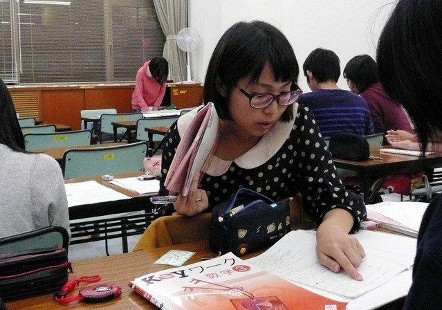 放課後の学習を支援する大学生＝神戸市内