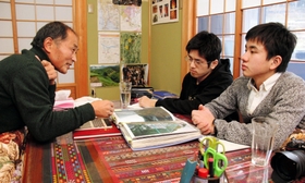 こたつを挟んで上野政志さん（左）の話を聞く田中謙太郎さん（右）、吉良崇志さん＝佐用町東徳久