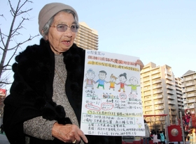 子どもたちが遊ぶ公園で慰霊祭のチラシを手にする斉木久美子さん＝六甲道南公園