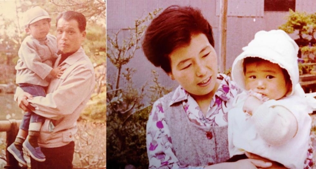 幼いころの伸也さんを抱く足立悦夫さん、朝子さん。かわいい末っ子には両親とも甘かった＝足立悦夫さん、朝子さん提供