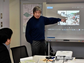 地図作りのため、被災地に花を植える活動について説明する「阪神大震災復興市民まちづくり支援ネットワーク」世話人の小林郁雄さん＝神戸市中央区脇浜海岸通１