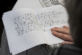 神戸市長宛ての手紙の写しを手にする女性＝神戸市兵庫区