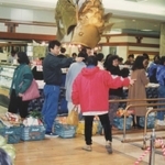 震災翌日、買い物かごに商品を山積みにし、並ぶ買い物客＝１９９５年１月１８日（同店提供）