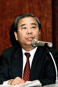 シンポジウムで被災者への公的支援の必要性を語る草地賢一さん＝１９９６年３月１６日、神戸市中央区、神戸国際会議場