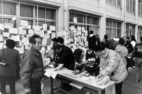 避難所となった学校には、無事や連絡先を知らせるメッセージを記した紙が張られた＝２０日、神戸市長田区