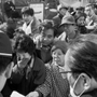 ビル倒壊現場前で、警察官らに情報を求める人たち。顔写真の付いた書類を差し出す女性も＝１９日、西宮市甲子園口北町