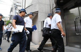 銃撃事件があった建物に入る兵庫県警の捜査員たち＝２２日午前、神戸市中央区熊内町９